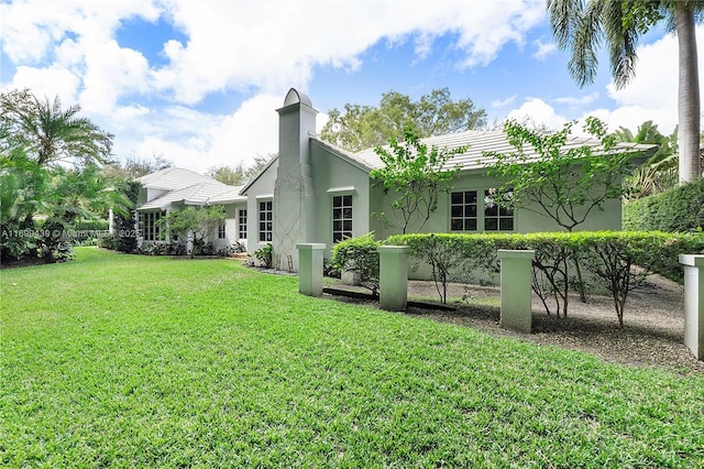 back of house with a lawn