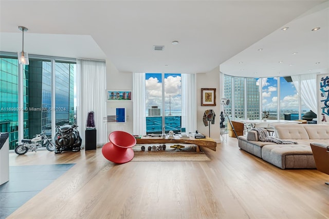 interior space featuring a wall of windows and light hardwood / wood-style flooring