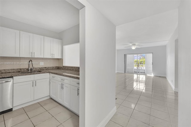 kitchen featuring sink, light tile patterned floors, dishwasher, white cabinetry, and backsplash