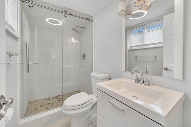 bathroom featuring vanity, an enclosed shower, and toilet