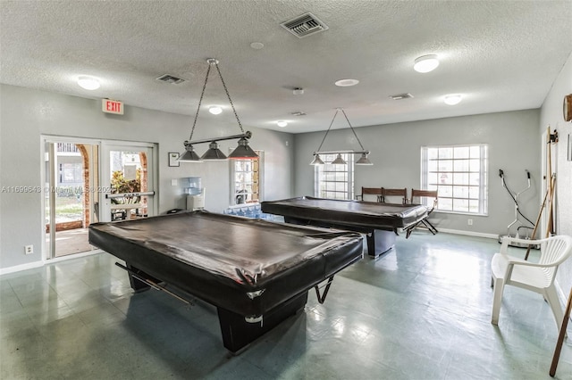 game room with a textured ceiling and pool table