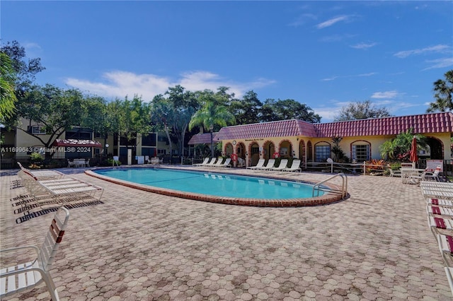 view of swimming pool with a patio area