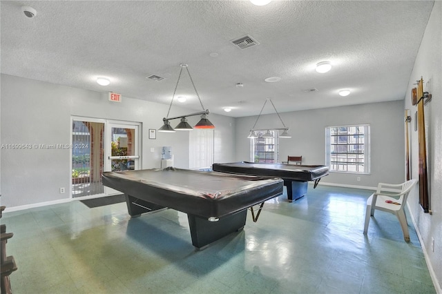 recreation room with a textured ceiling and billiards