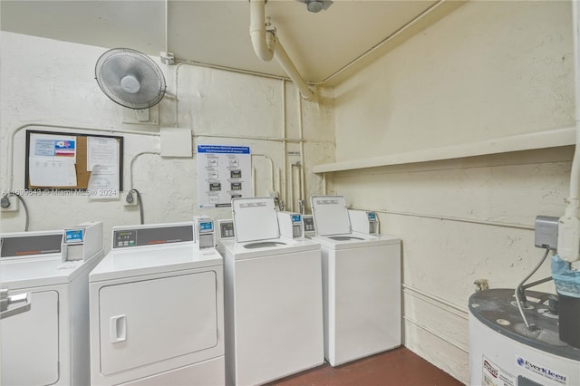 clothes washing area featuring washing machine and dryer and water heater