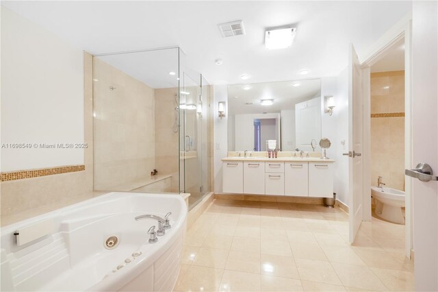 bathroom featuring tile patterned floors, vanity, a bidet, and independent shower and bath