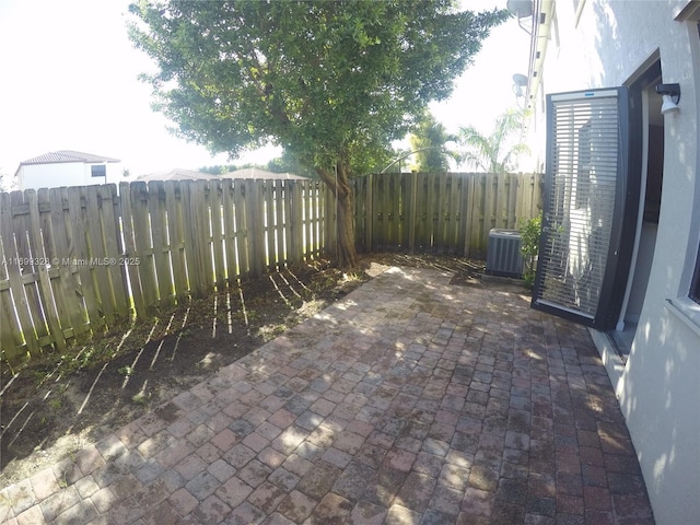 view of patio / terrace with central AC unit and a fenced backyard