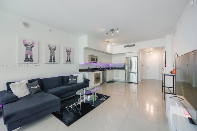 living room with visible vents and light tile patterned floors