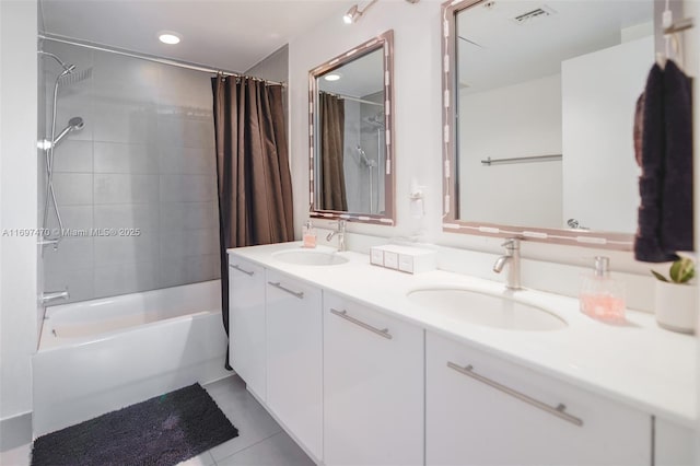 full bathroom featuring double vanity, visible vents, a sink, and shower / bath combo with shower curtain