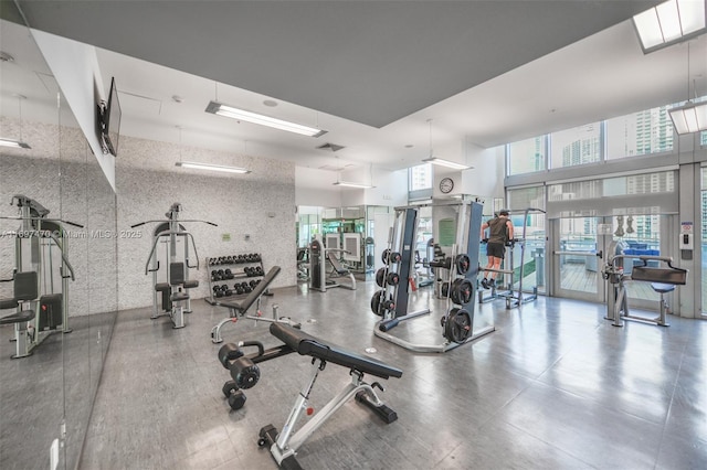 workout area with a towering ceiling