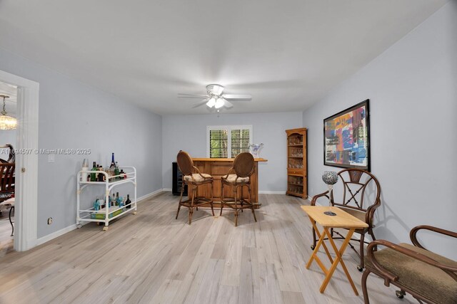6065 SW 133rd St, Pinecrest, FL 33156 - dining space with ceiling fan, light wood-type flooring, baseboards, and a dry bar