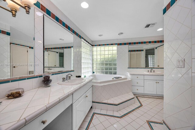 6065 SW 133rd St, Pinecrest, FL 33156 - full bathroom with tile walls, a bath, two vanities, tile patterned floors, and recessed lighting