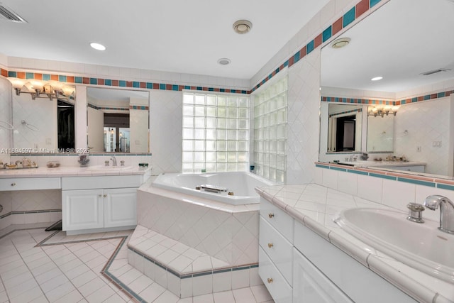 6065 SW 133rd St, Pinecrest, FL 33156 - bathroom featuring a garden tub, two vanities, tile patterned flooring, recessed lighting, and tasteful backsplash