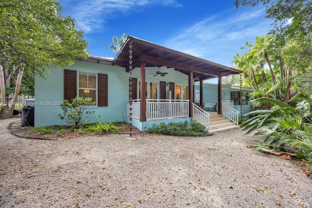 6065 SW 133rd St, Pinecrest, FL 33156 - view of front facade featuring covered porch, a ceiling fan, and stucco siding