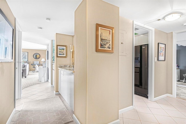 hall featuring light tile patterned floors