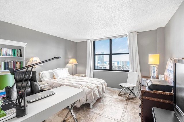 tiled bedroom featuring a textured ceiling