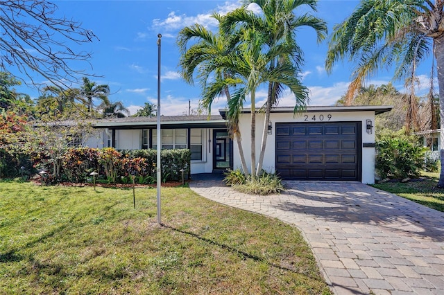 ranch-style home featuring a garage and a front yard