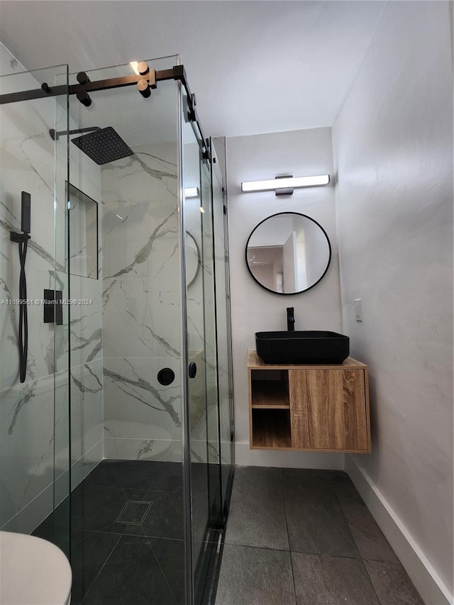 bathroom featuring tile patterned flooring, vanity, toilet, and walk in shower