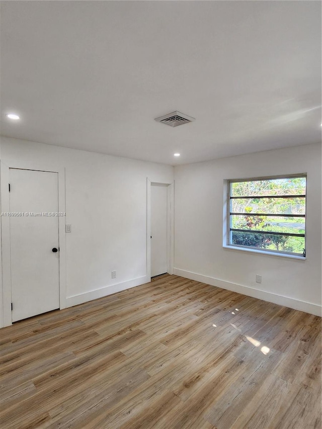 spare room featuring light wood-type flooring