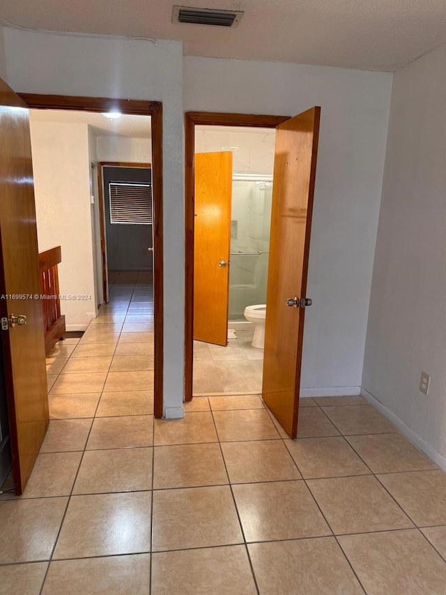 corridor featuring light tile patterned flooring