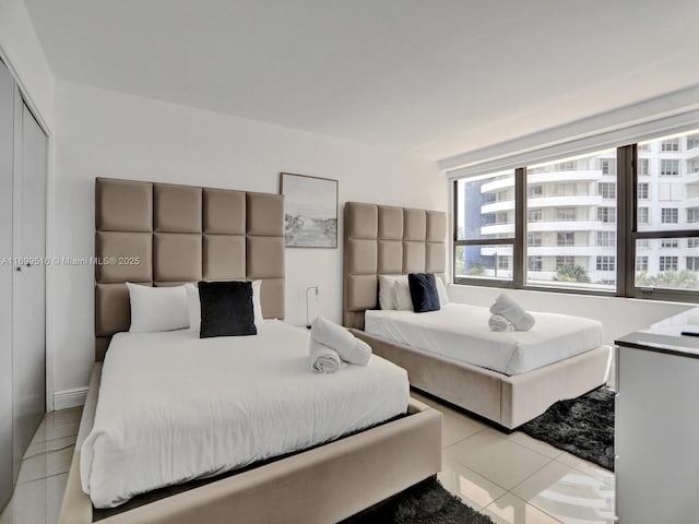 tiled bedroom featuring a closet