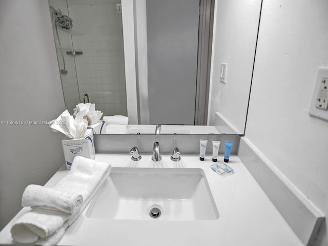 room details featuring vanity and a shower with shower door