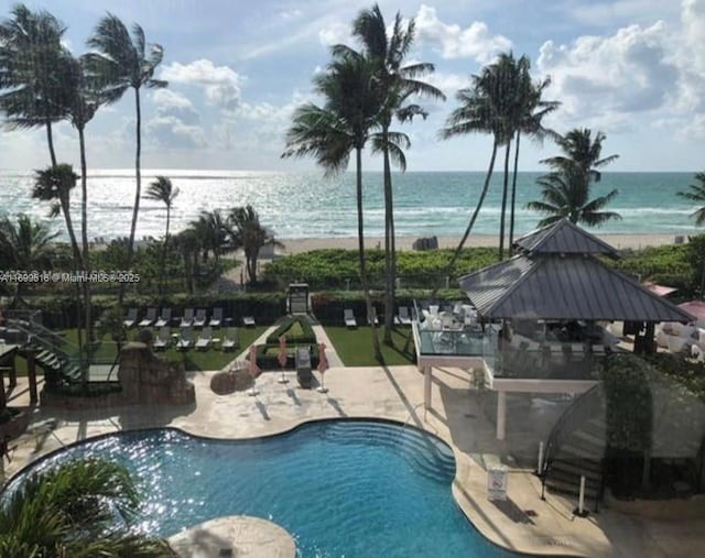 view of pool featuring a gazebo, a patio area, and a water view