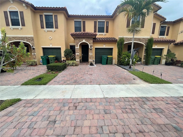 mediterranean / spanish-style house with a garage