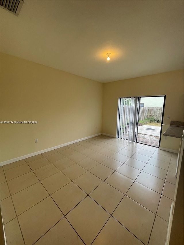 unfurnished room featuring light tile patterned floors