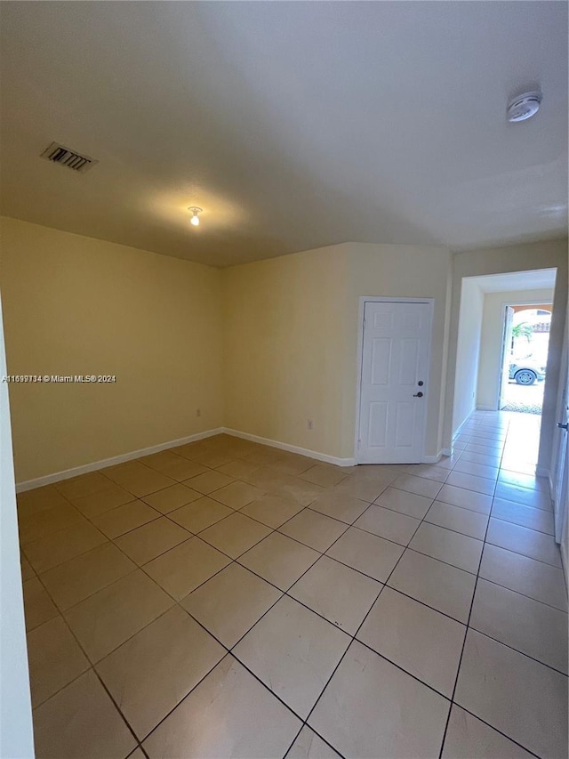 unfurnished room with light tile patterned flooring