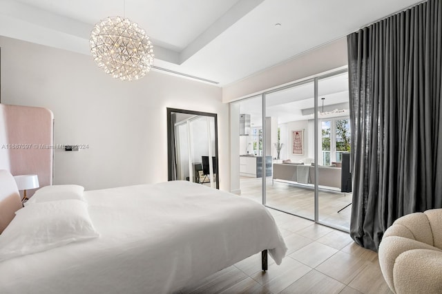 bedroom with wood-type flooring, a closet, and a notable chandelier