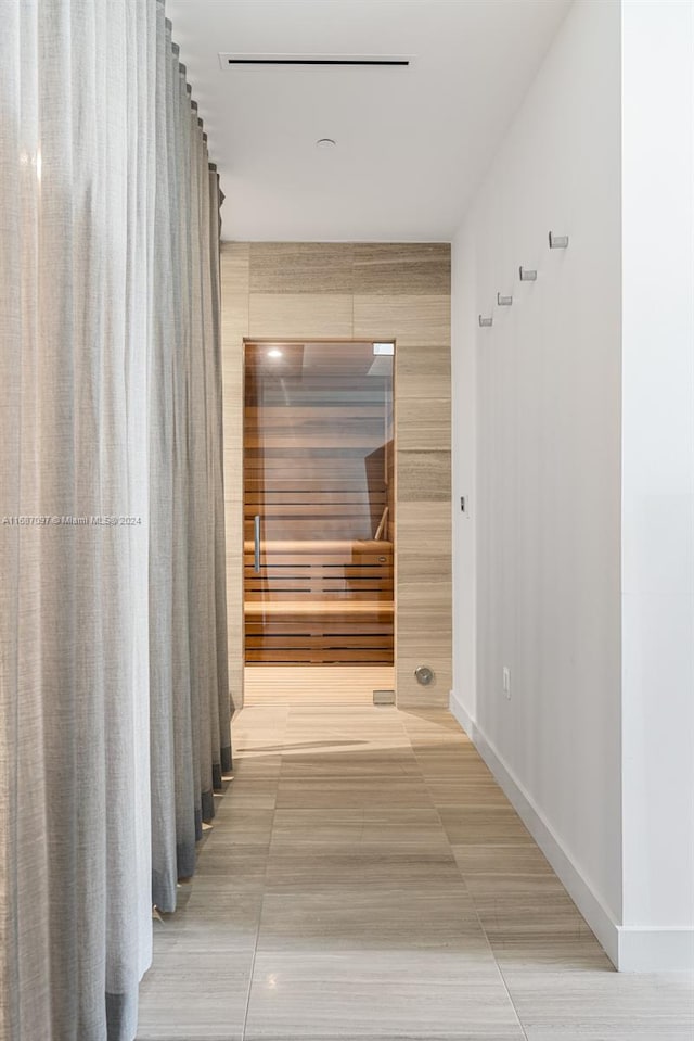 corridor featuring tile patterned flooring