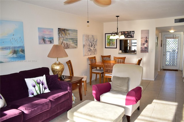 living room featuring ceiling fan with notable chandelier and light tile patterned floors