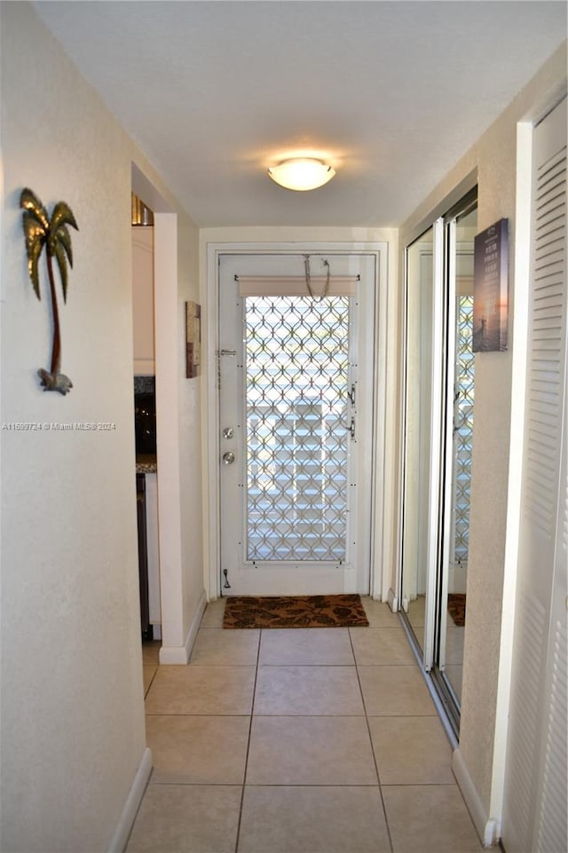 entryway featuring light tile patterned floors