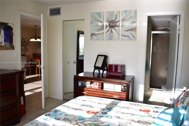 bedroom featuring tile patterned floors, ceiling fan, and a textured ceiling