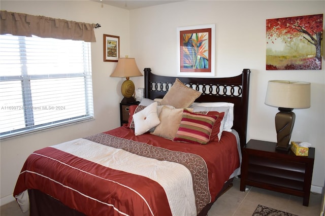 tiled bedroom with an inviting chandelier and a closet