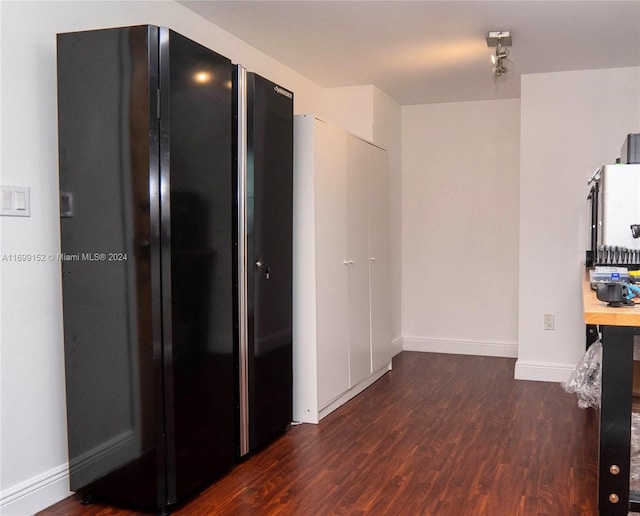 corridor with dark hardwood / wood-style floors