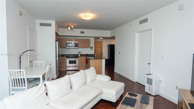 living room featuring sink and dark hardwood / wood-style floors