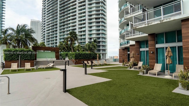 view of property's community with a pergola and a yard