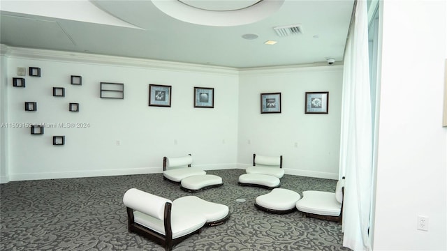 living area with carpet flooring and ornamental molding