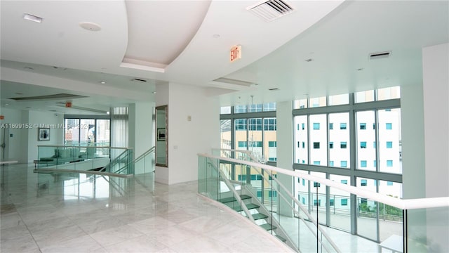 hallway with floor to ceiling windows