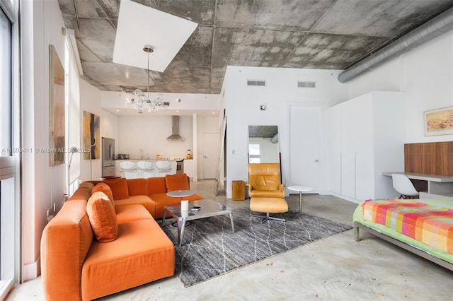 bedroom with concrete floors, visible vents, a notable chandelier, and freestanding refrigerator