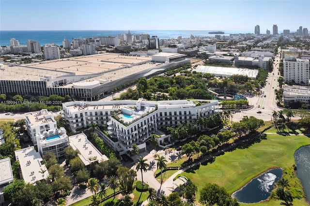 birds eye view of property with a water view and a city view