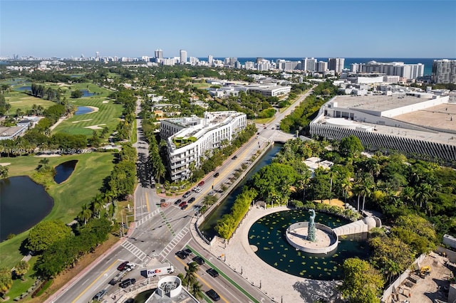 aerial view with view of golf course, a water view, and a city view