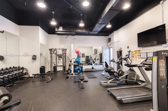 workout area featuring a high ceiling