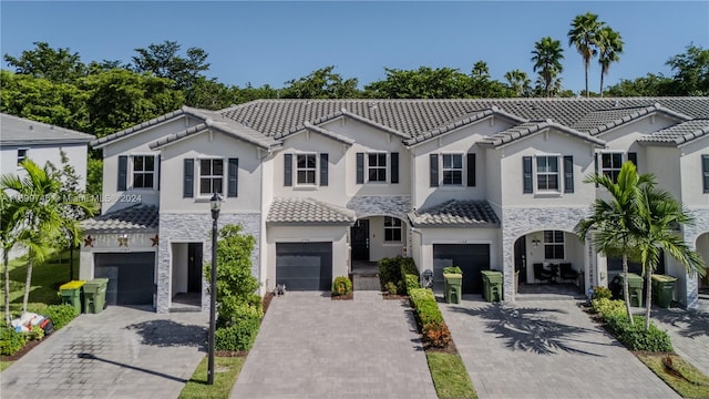 mediterranean / spanish-style house with a garage