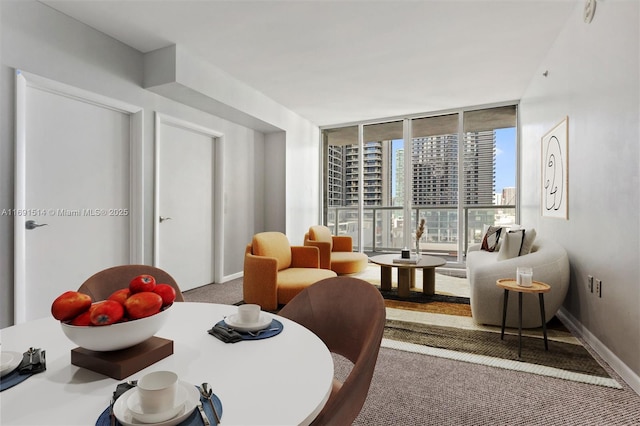 dining area with a wall of windows and carpet