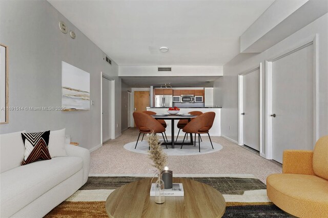 carpeted dining area featuring expansive windows