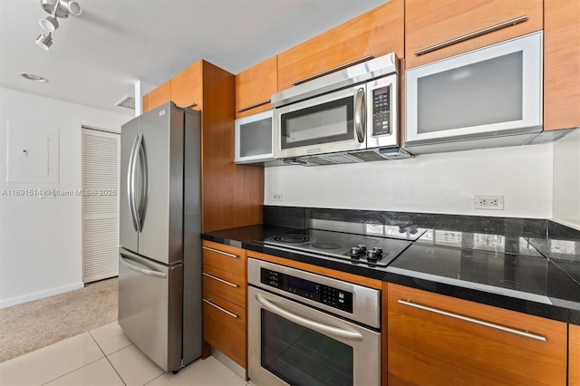 kitchen featuring light tile patterned floors, electric panel, and appliances with stainless steel finishes