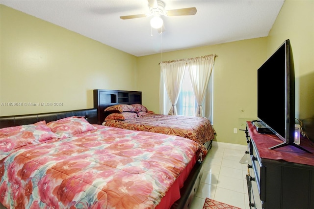 bedroom with ceiling fan and light tile patterned flooring