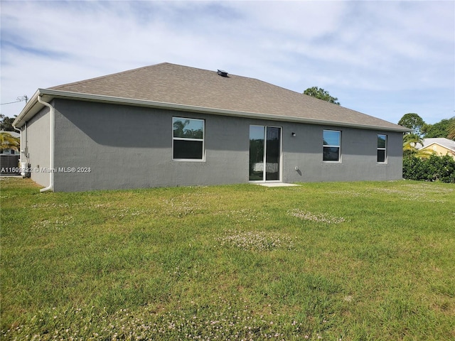 back of house with a yard